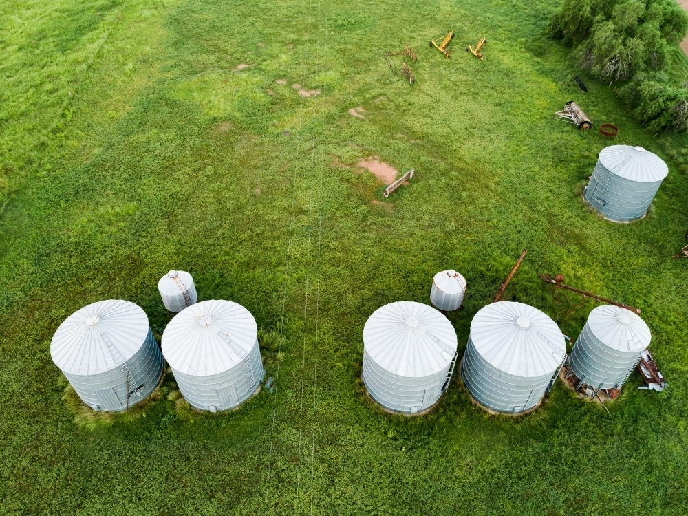 Silos on farm from above in green paddocks - Australian Stock Image
