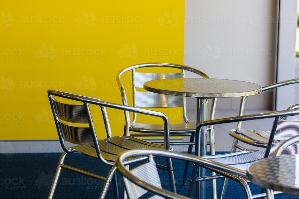 silver chairs and tables in an empty cafe - Australian Stock Image