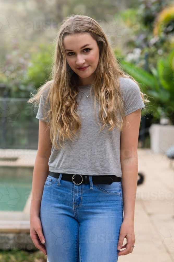 simple portrait of pretty teen in jeans and tee-shirt - Australian Stock Image