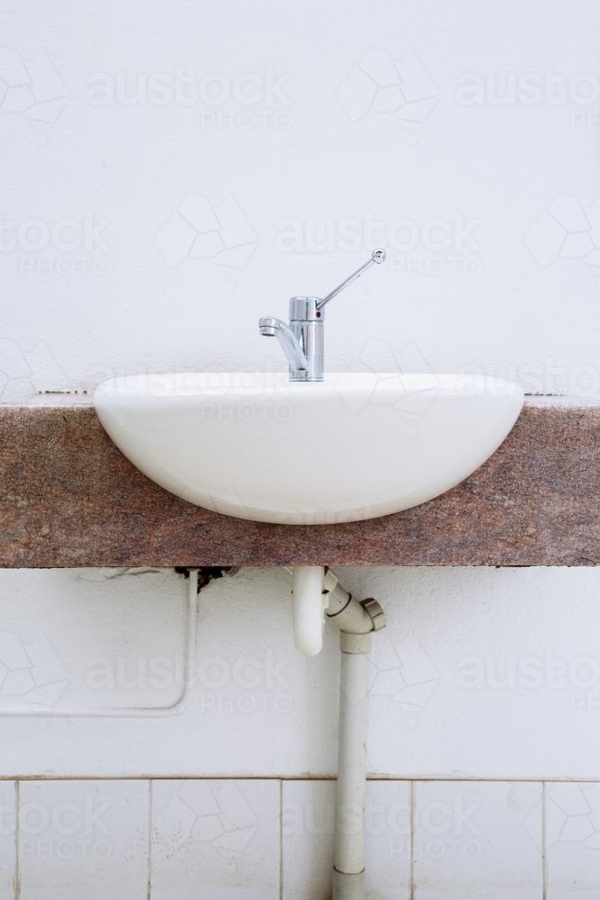 Sink in an outdoor public toilet. - Australian Stock Image