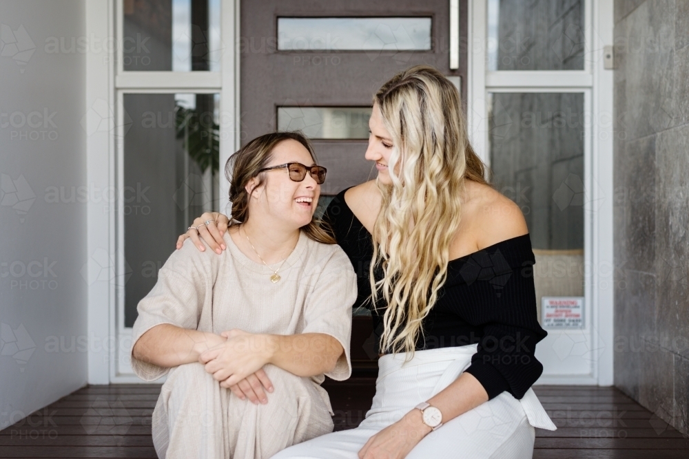 Image of sisters hugging. from a lifestyle series featuring a young