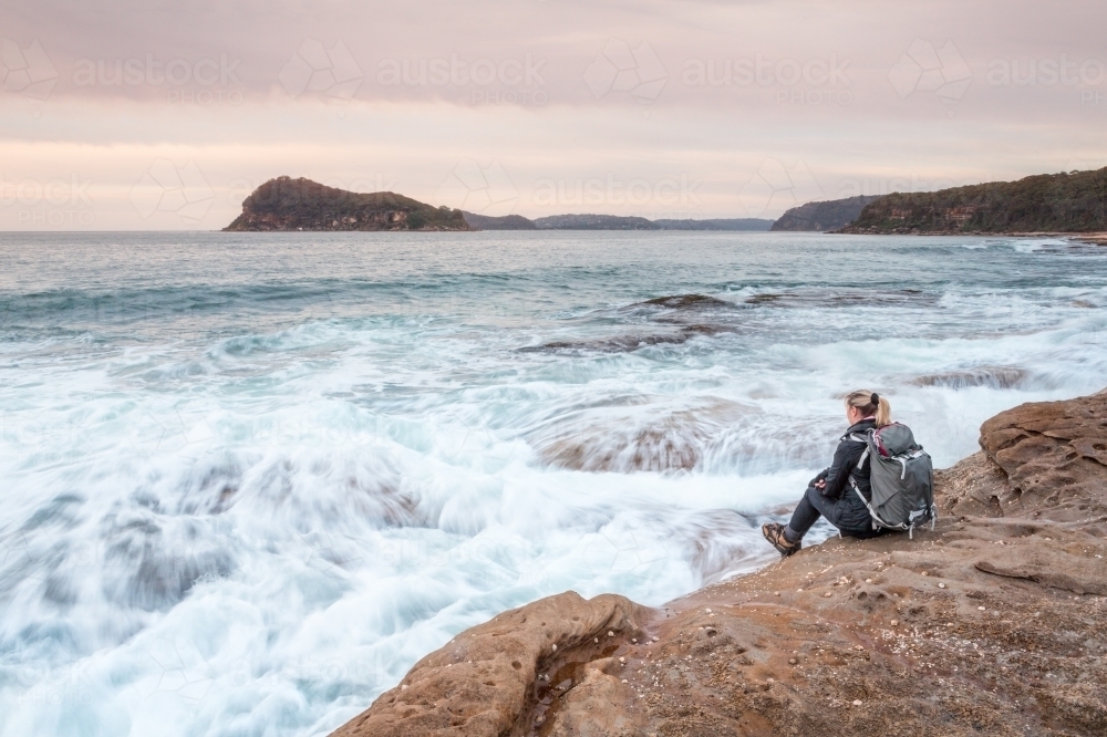 Sitting by the shore letting the waves wash in to meet you. - Australian Stock Image