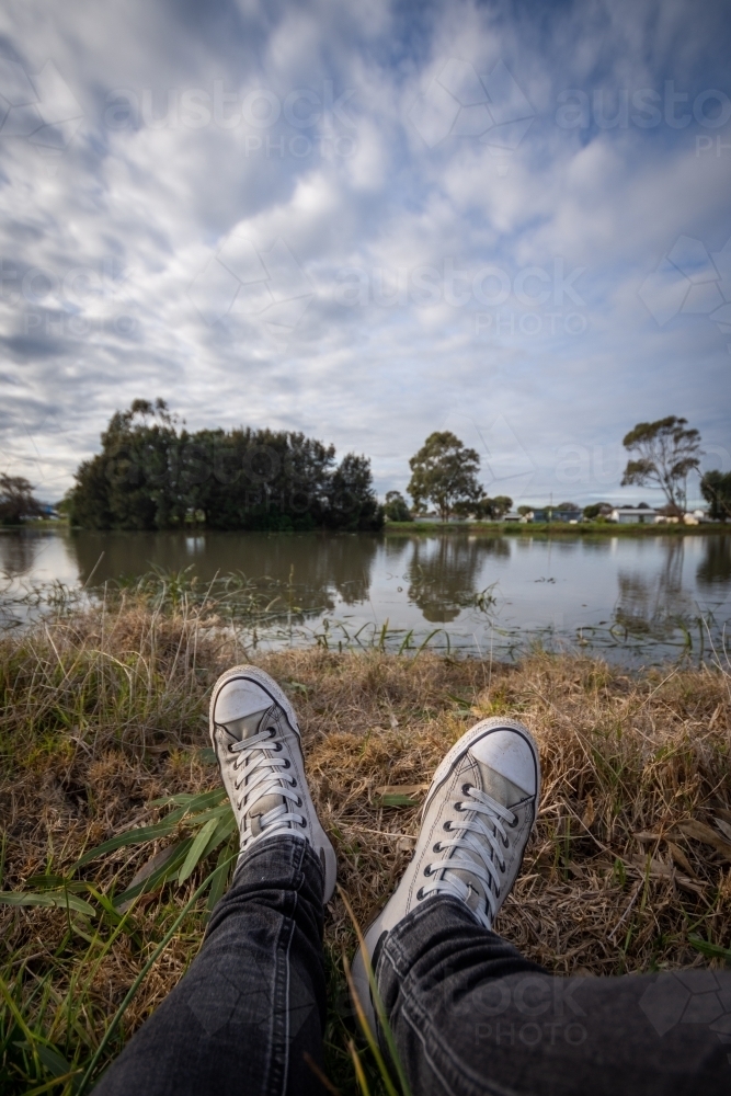Sitting in the grass beside a local pond - Australian Stock Image