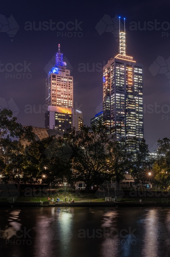 sitting under a light on the edge of the Yarra River, Melbourne - Australian Stock Image