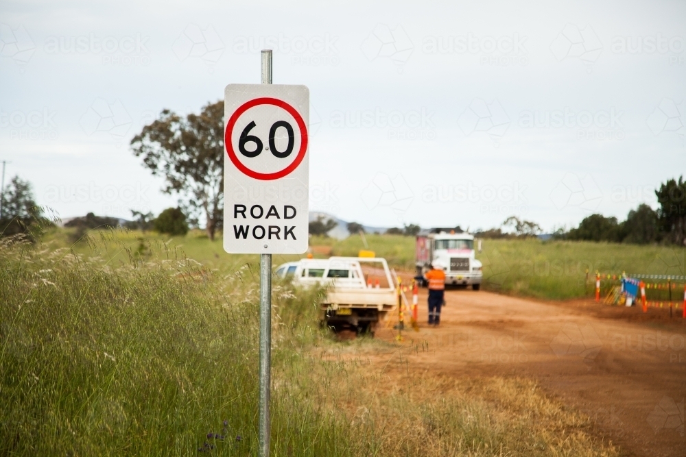 Sixty road work sign near rural highway construction - Australian Stock Image