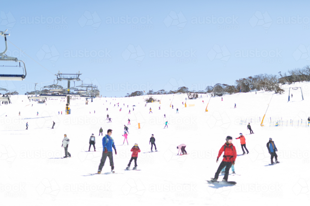 Image of Ski slope at Perisher with skiers and boarders and chair lift ...