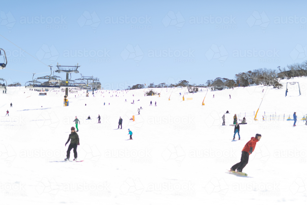 Image of Ski slope at Perisher with skiers and boarders and chair lift ...