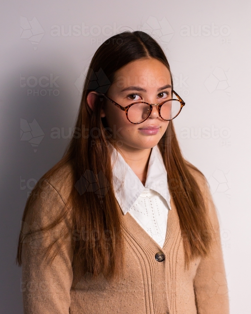 sky teen girl wearing a cardigan and glasses - Australian Stock Image