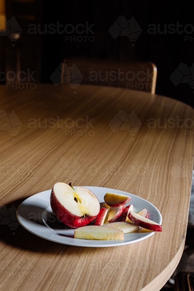 sliced apple on a plate on a table - Australian Stock Image
