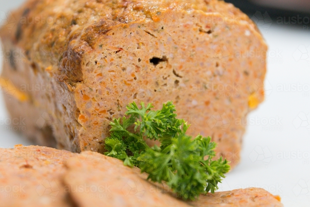 Sliced meatloaf in butchers shop with parsley garnish : Austockphoto Sliced meatloaf in butchers shop with parsley garnish - Australian Stock Image