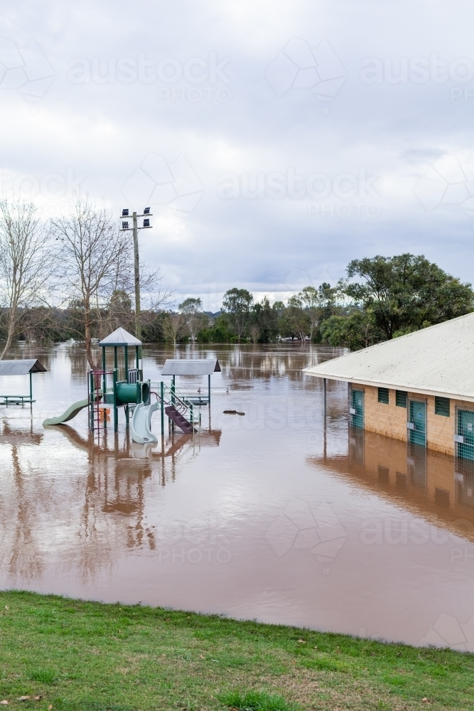 Image of Slippery dip slide and playground at park under water during