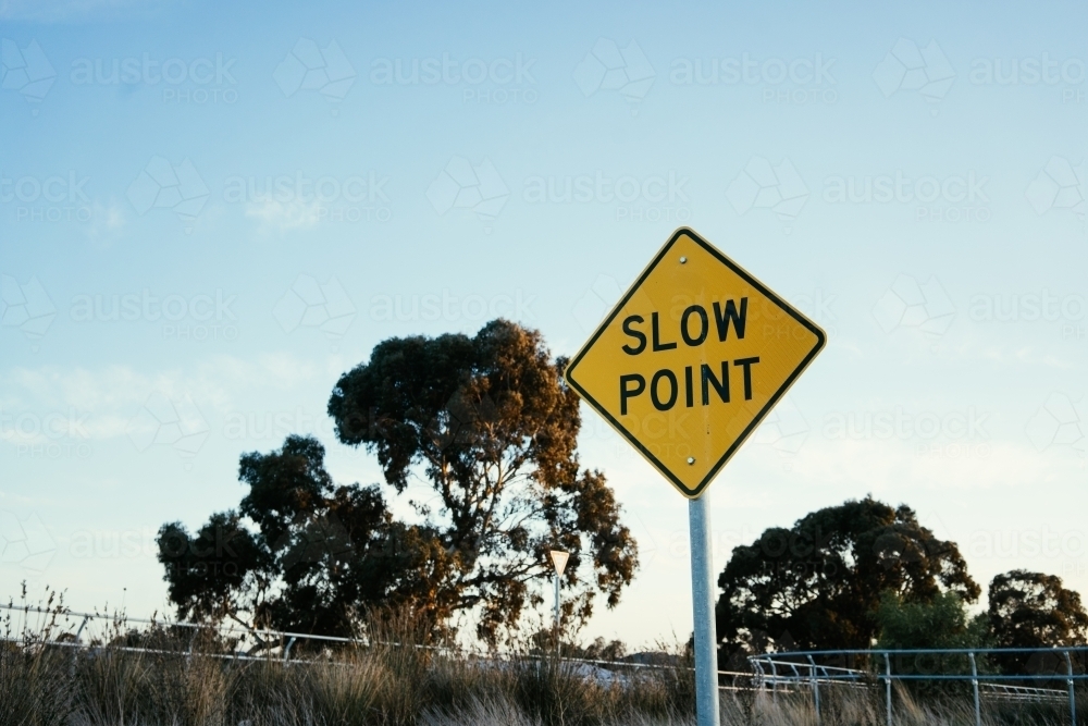Slow Point bike path road sign landscape with trees in background - Australian Stock Image