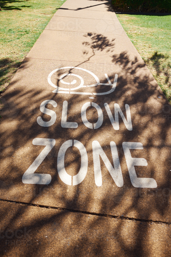 Slow Zone Sign painted on footpath - Australian Stock Image
