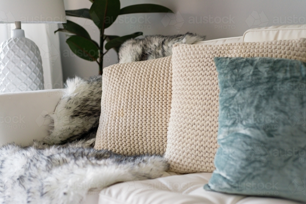 small apartment interior, detail of cushions on a sofa - Australian Stock Image