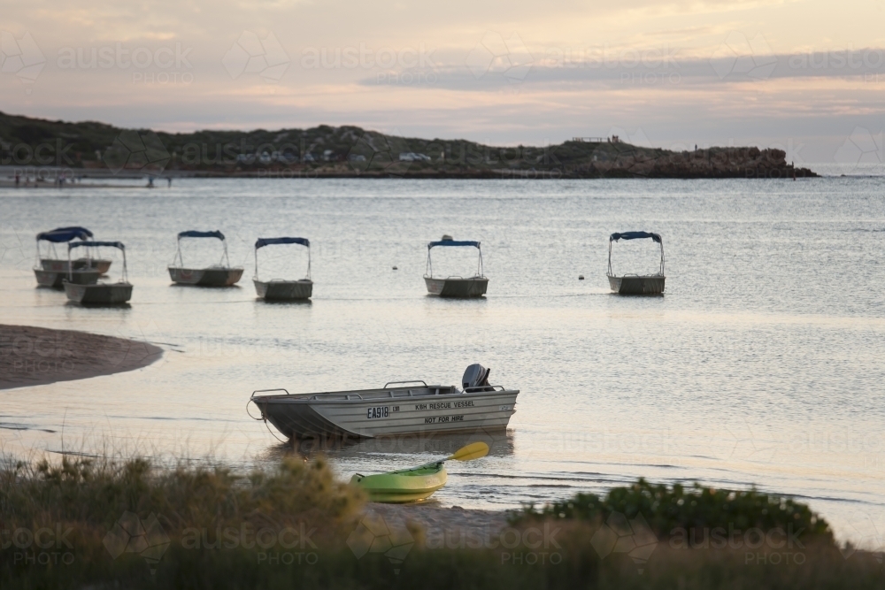 Small boats in harbour at sunset - Australian Stock Image