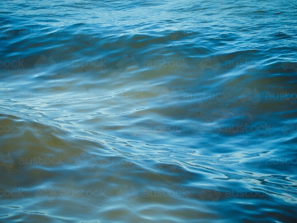 Small, calm waves in the ocean - Australian Stock Image