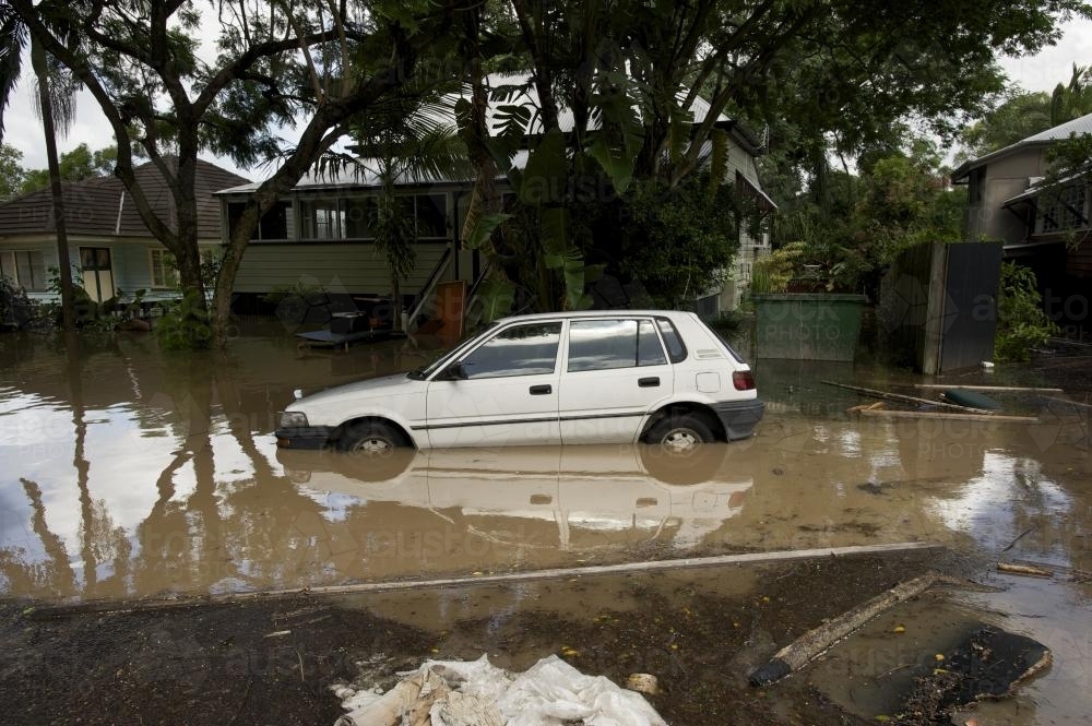 small car floating in a flooded street, 2011 Brisbane floods - Australian Stock Image