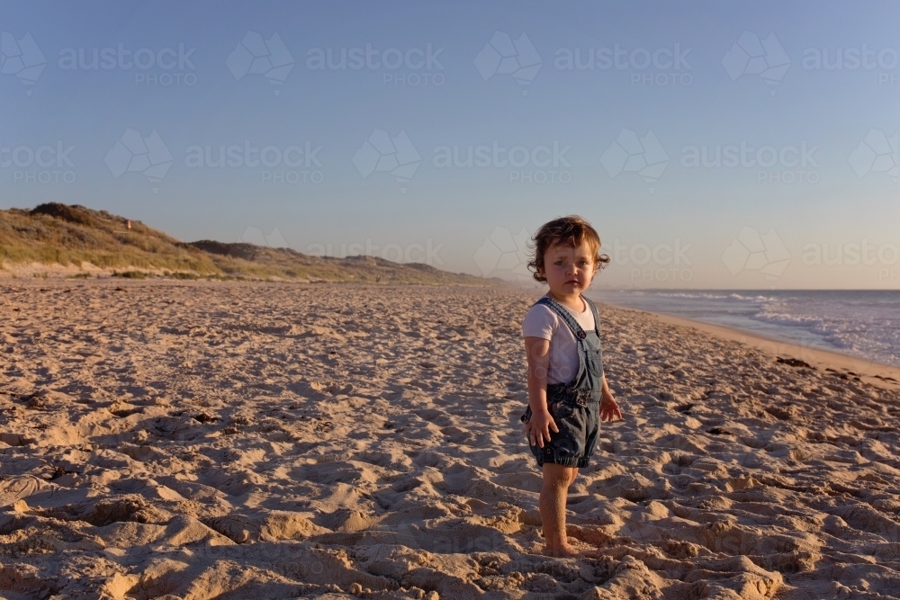 Small Child On The Beach At Sunset - Australian Stock Image