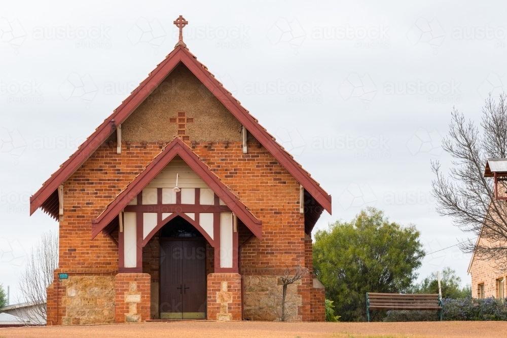 Small country church with cross on gabled roof - Australian Stock Image