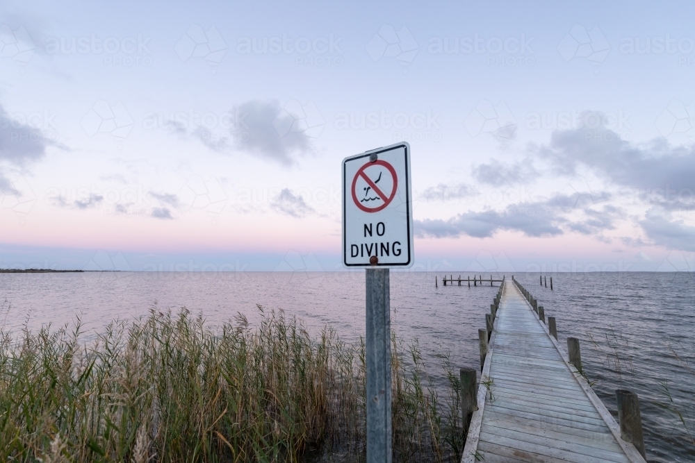 small jetty on lake at sunset - Australian Stock Image