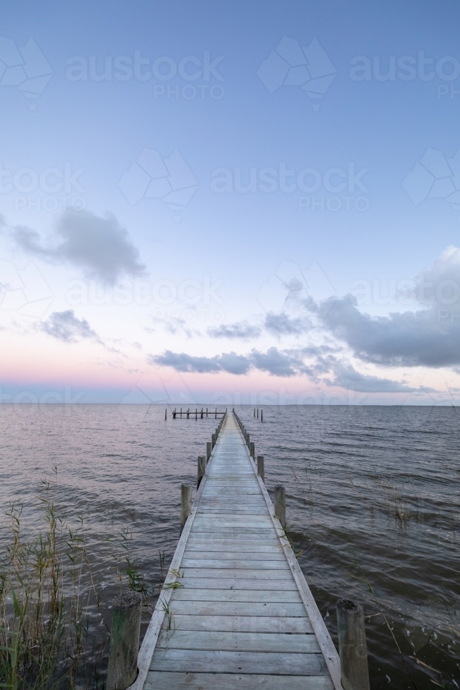 small jetty on lake at sunset - Australian Stock Image