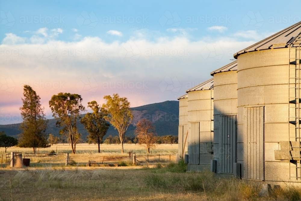 Small metal grain silos on rural farm property - Australian Stock Image