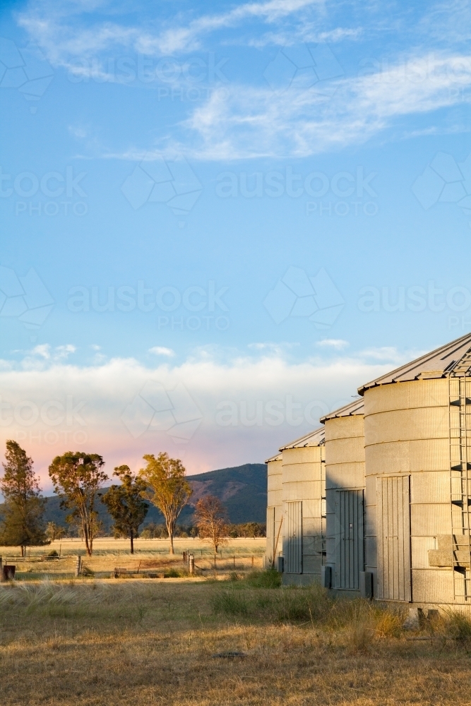 Small metal grain silos on rural farm property - Australian Stock Image