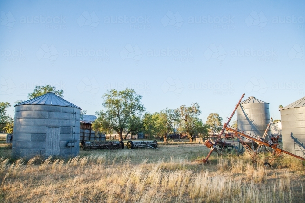 Small metal grain silos on rural farm property - Australian Stock Image