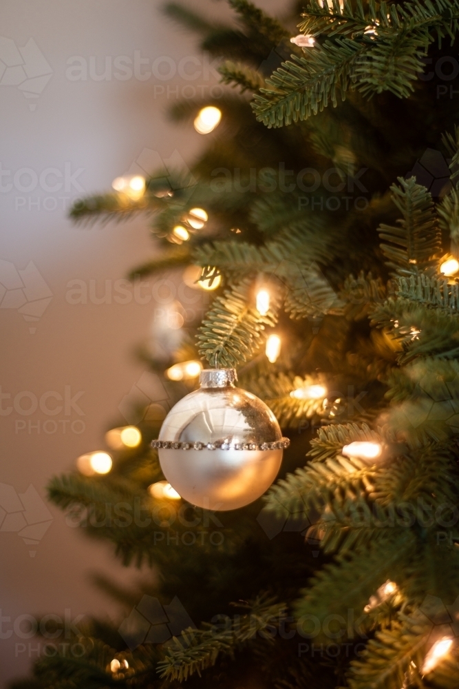 small simple ball on xmas tree with lights - Australian Stock Image