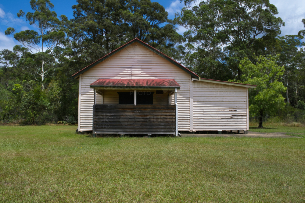 Small timber hall in countryside on a sunny day with gum trees - Australian Stock Image