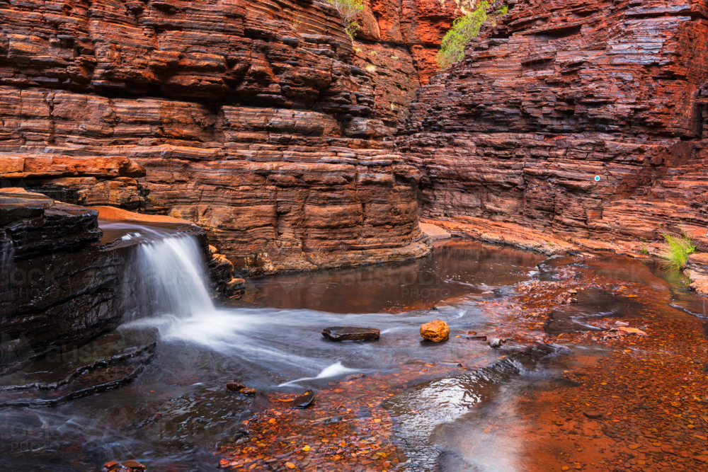 Small waterfalls deep inside a gorge in karijini national park - Australian Stock Image