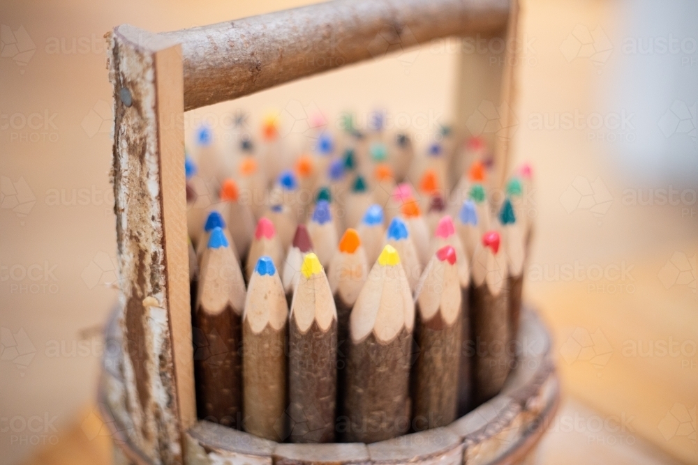 Small wooden bucket holding pencils - Australian Stock Image