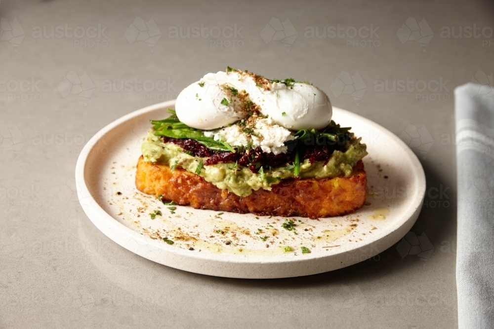 Smashed avocado and eggs on gluten free toast - Australian Stock Image