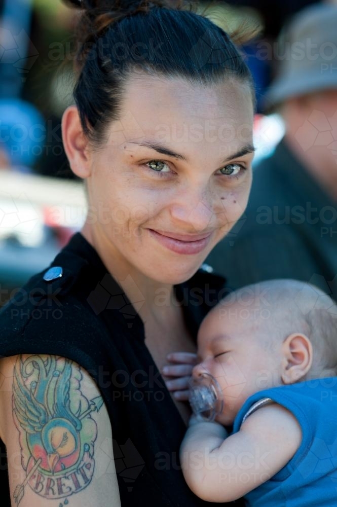 Smiling Aboriginal Woman with Baby - Australian Stock Image