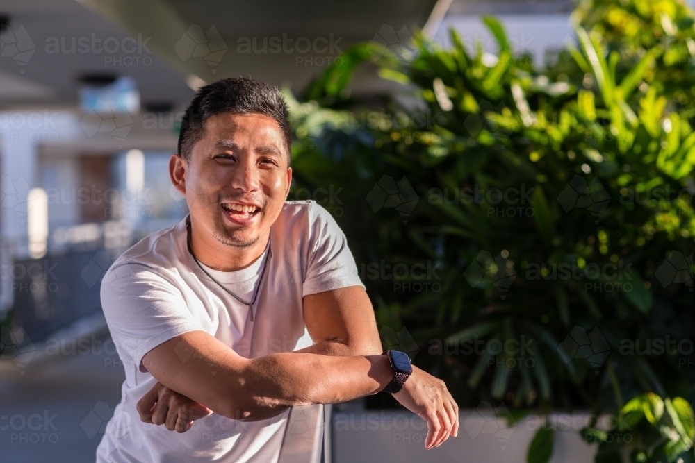 smiling asian man in the sun - Australian Stock Image