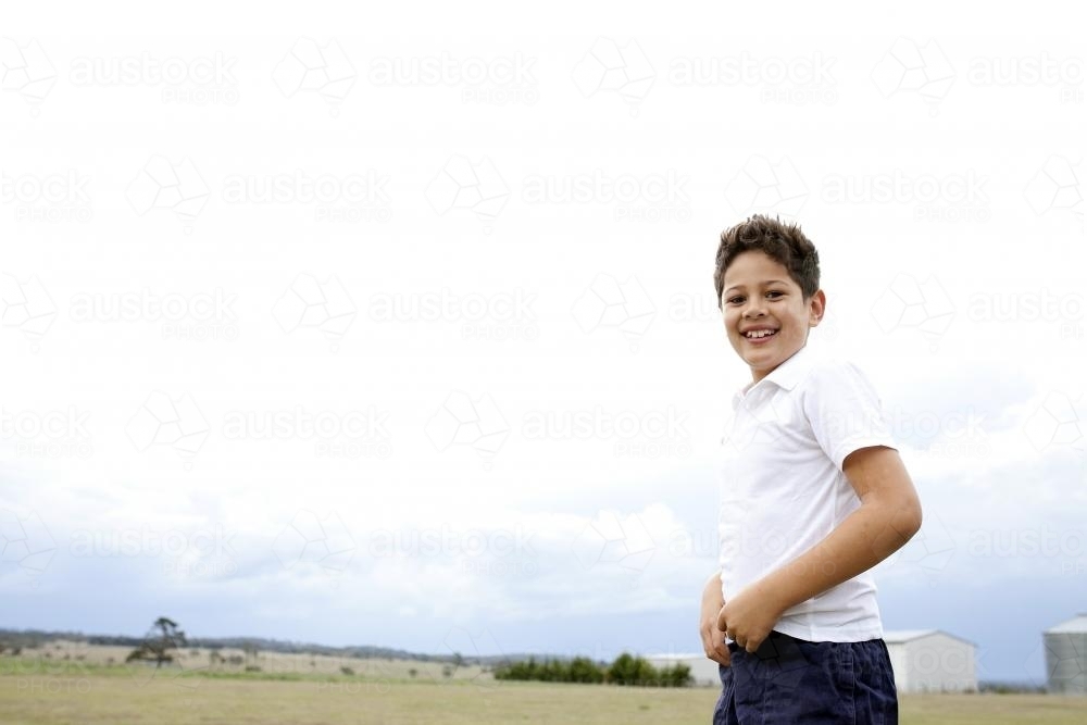 Smiling boy playing outside on the farm - Australian Stock Image