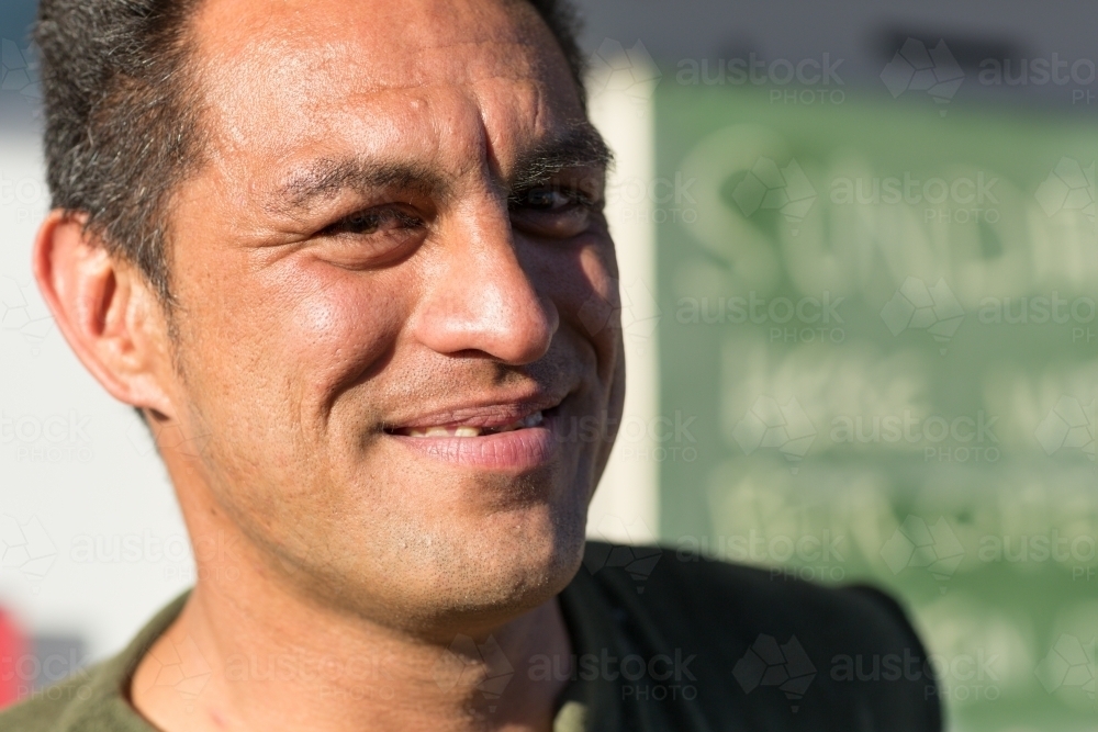 Smiling man, full face in afternoon sun - Australian Stock Image