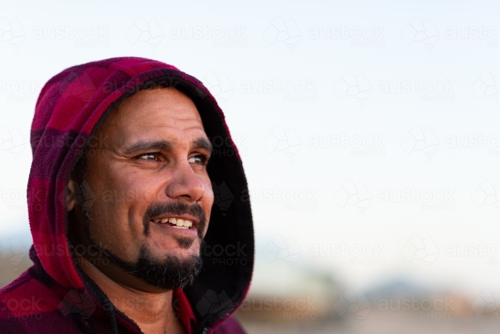 Smiling man wearing hoody head and shoulders - Australian Stock Image