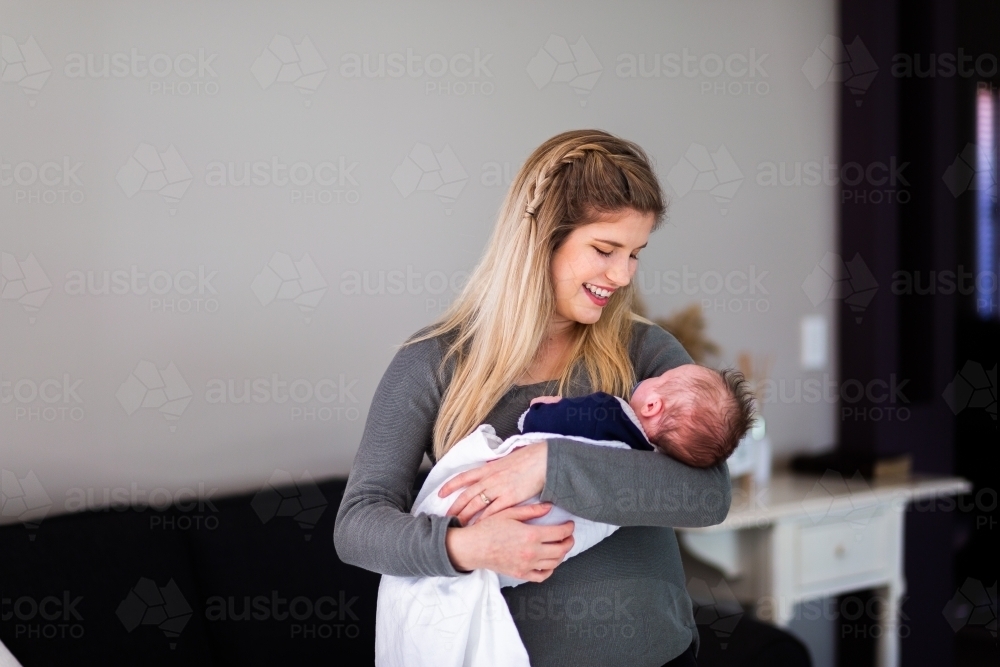 Smiling mother with newborn - Australian Stock Image