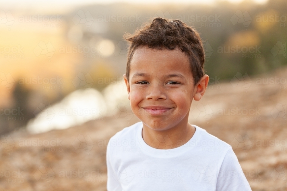 Smiling portrait of six year old australian kid of aboriginal ethnicity - Australian Stock Image