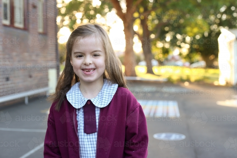 Image of Smiling school girl in playground - Austockphoto