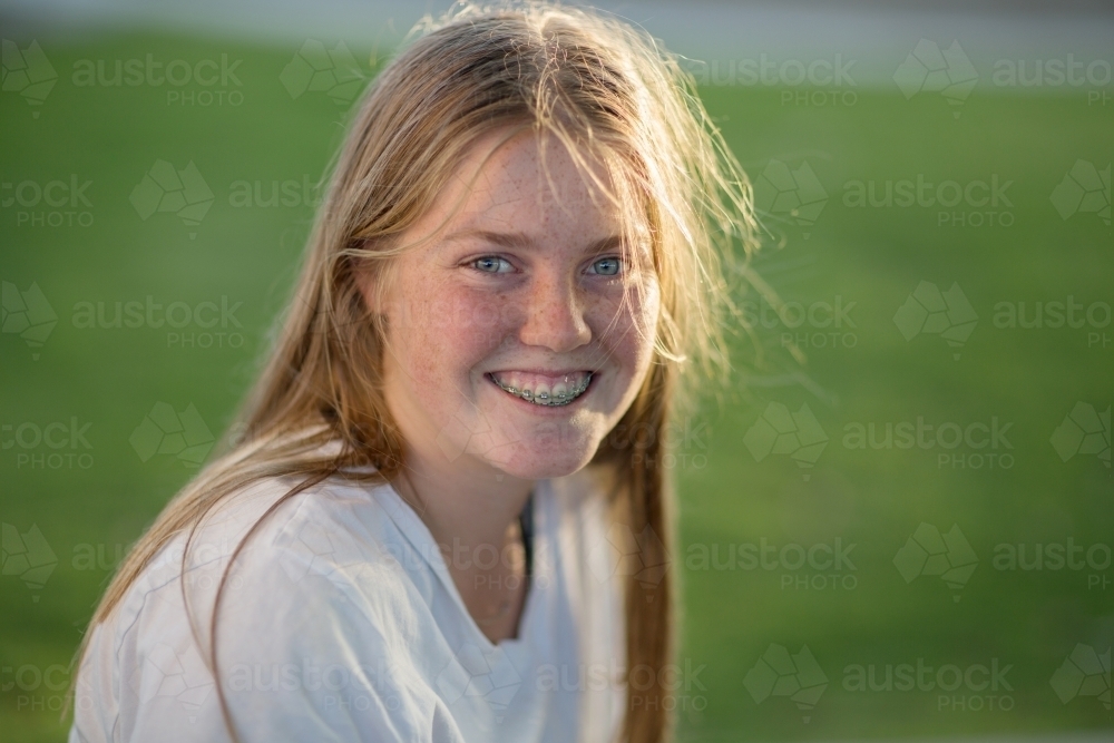 Smiling teenage girl with dental braces - Australian Stock Image