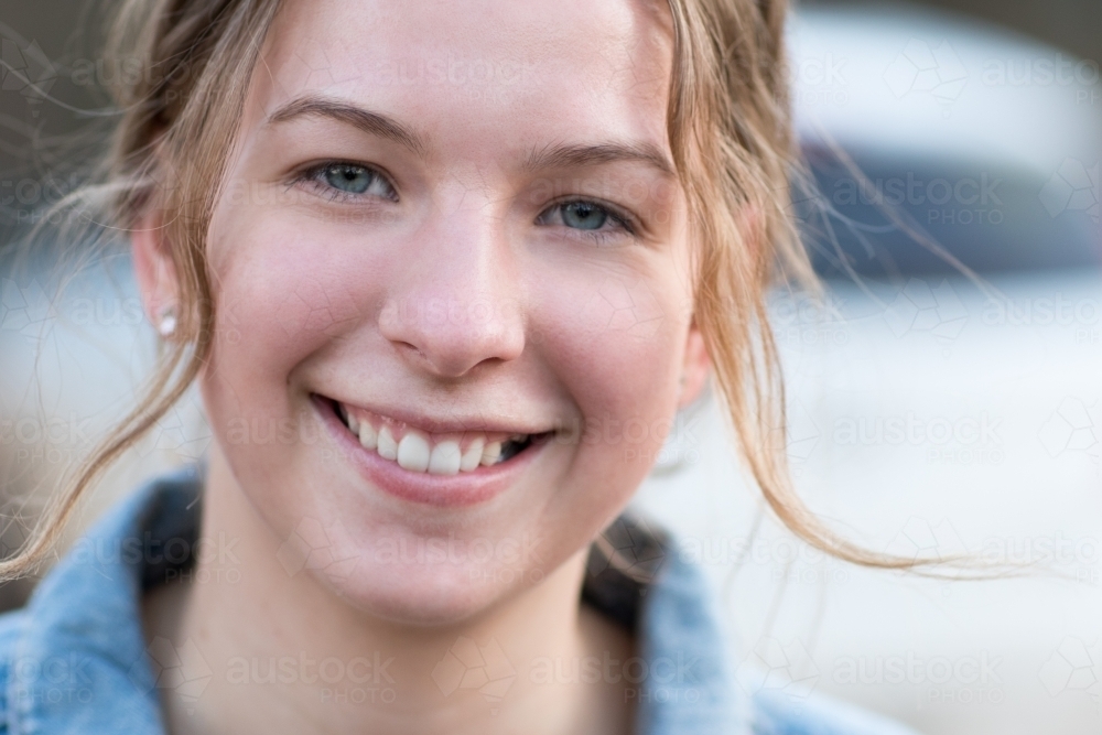 Smiling teenage girl with flyaway hair - Australian Stock Image