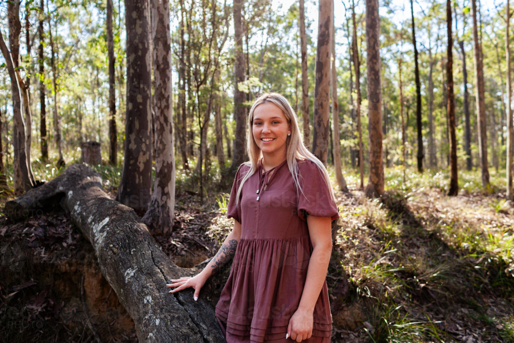 Smiling woman in her twenties standing in national park bushland in Hunter Valley in Australia - Australian Stock Image