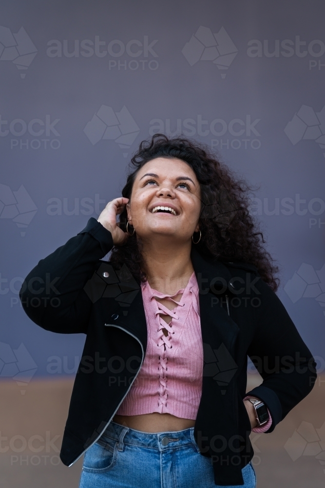 smiling woman looking up, with copy space - Australian Stock Image
