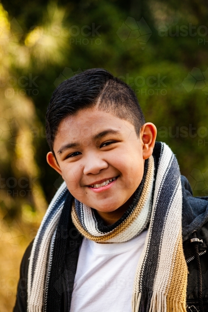 Smiling young Filipino boy with scarf - Australian Stock Image