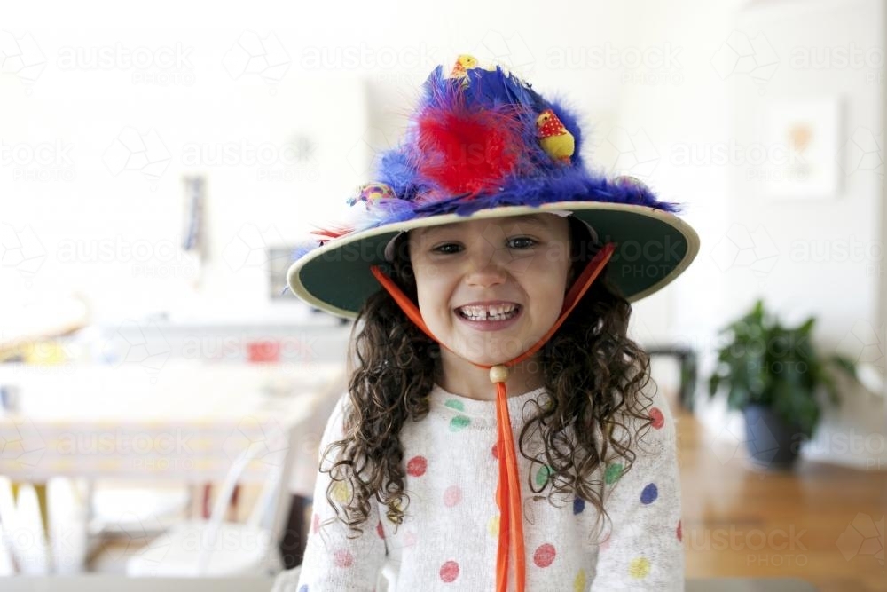 Smiling young girl wearing hand made Easter hat - Australian Stock Image