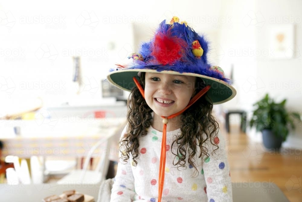 Smiling young girl with hand made easter hat - Australian Stock Image