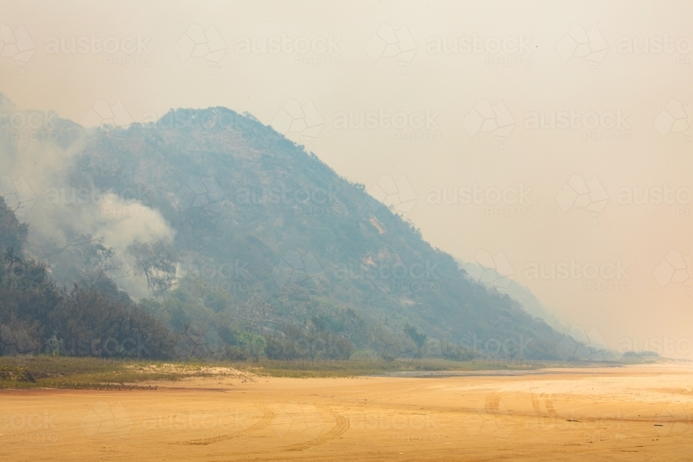 Smoke along the eastern beach of Fraser Island from a bushfire - Australian Stock Image