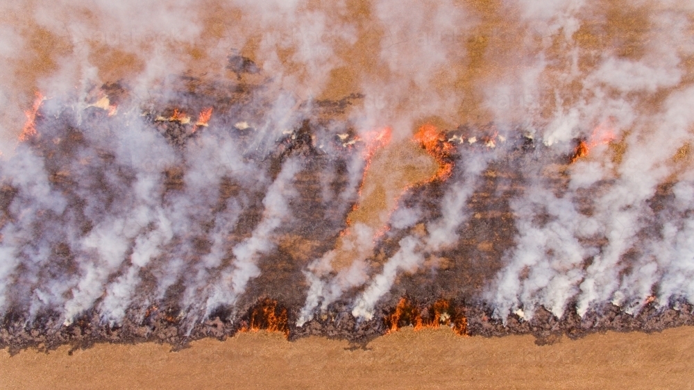 Smoke from fires blackening paddock as stubble burns - Australian Stock Image